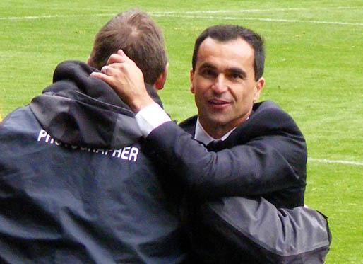 Roberto Martinez is embraced by a photographer